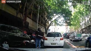 A Delivery Driver On A Scooter Crashed Straight Into An Open Car Door