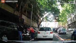 A Delivery Driver On A Scooter Crashed Straight Into An Open Car Door