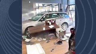 Guy Drives His Car Through The Dealership