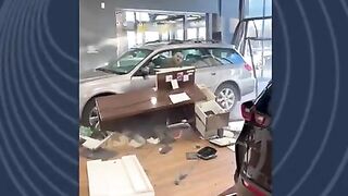 Guy Drives His Car Through The Dealership