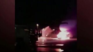 Firefighters Battle To Save Plane As Truck Tows Away Passenger Jet