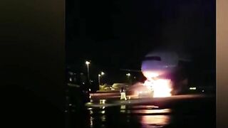 Firefighters Battle To Save Plane As Truck Tows Away Passenger Jet
