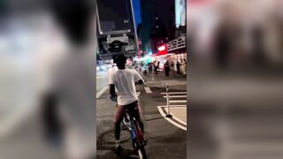 A Cyclist Carries A Refrigerator On His Head