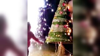 Fireworks Are Set Off On Both Sides Of The Glowing Christmas Tree