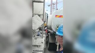 Man Trapped Between Trucks