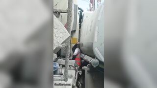 Man Trapped Between Trucks