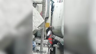 Man Trapped Between Trucks