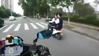 Motorcyclist Giving Middle Finger To Moped Driver