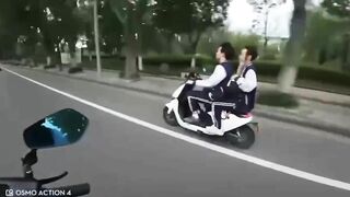 Motorcyclist Giving Middle Finger To Moped Driver