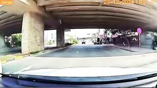 Speeding Motorbike Rider Falls Face Down Behind Truck