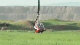 Small Helicopter Rotors Touching The Ground During Takeoff