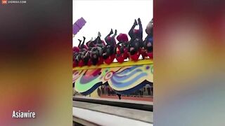 Thrill Seekers Hang Upside Down On Amusement Park Ride