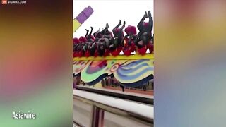 Thrill Seekers Hang Upside Down On Amusement Park Ride