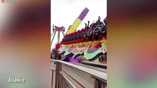 Thrill Seekers Hang Upside Down On Amusement Park Ride